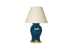 Dennis table lamp in Prussian Blue Glaze with 23k Gold Base and Cap, Brass Double Socket Cluster, and Off White Vellum Paper Lampshade, on a white background.