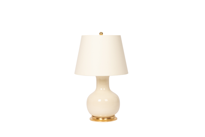 White table lamp with a gold base on a white background