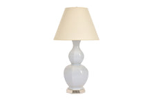 Large Alexander lamp in hope blue glaze with 12k white gold base, nickel double socket cluster, and off white vellum paper shade, on a white background.