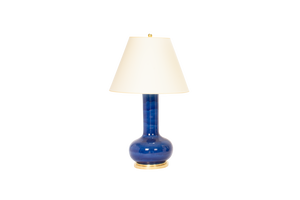 Large Ashley lamp in sapphire blue glaze with 23k gold base, brass double socket cluster, and off white vellum paper shade, on a white background.
