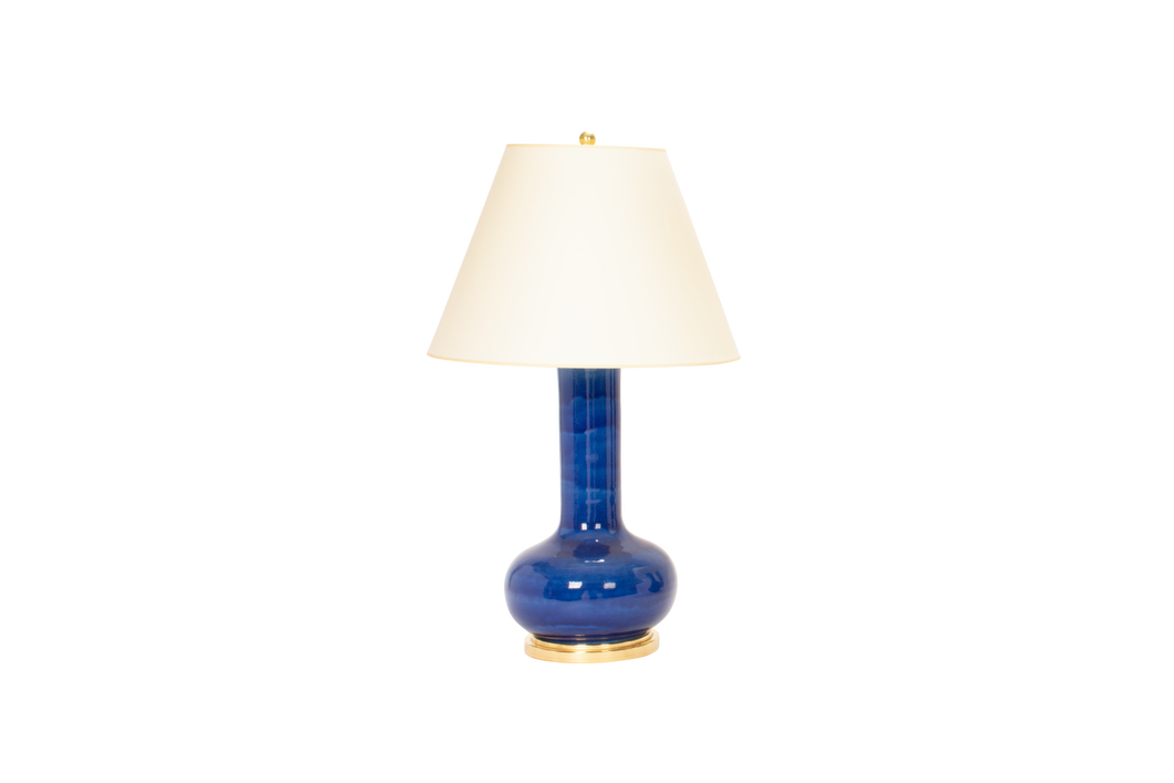 Large Ashley lamp in sapphire blue glaze with 23k gold base, brass double socket cluster, and off white vellum paper shade, on a white background.
