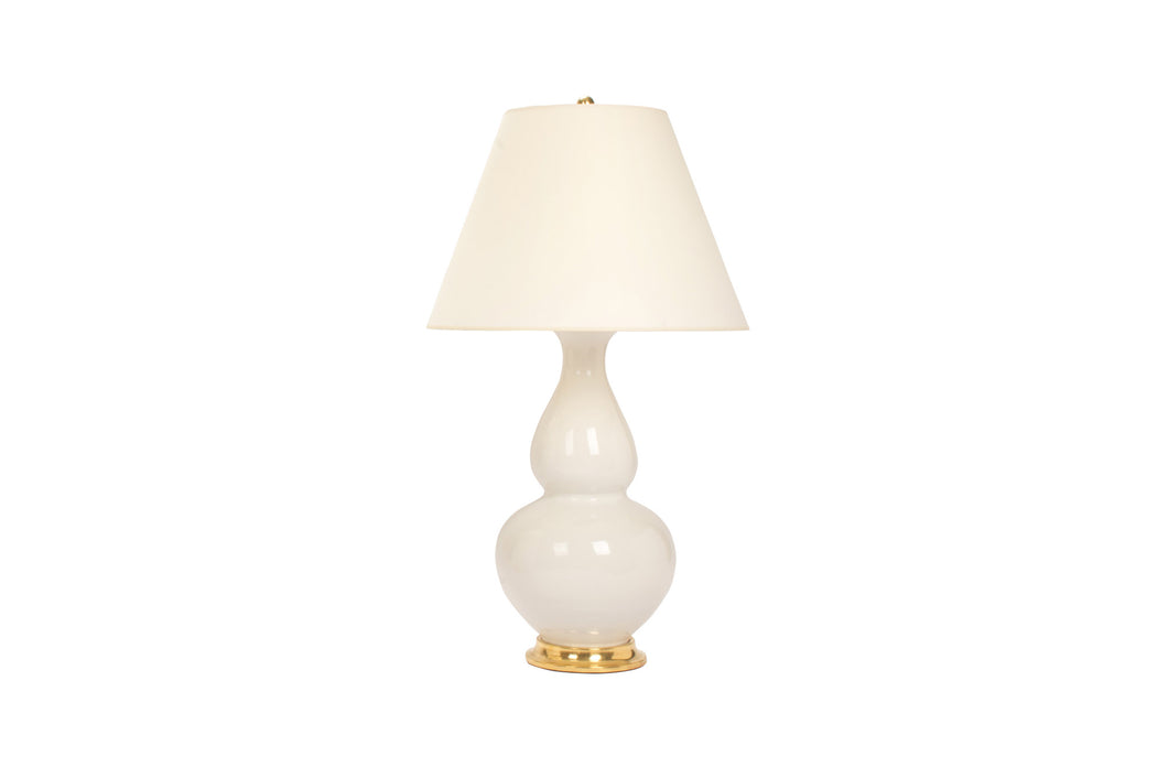 Aurora lamp in white blanc de chine glaze with 23k gold base, brass double socket cluster, and off white vellum paper shade, on a white background.