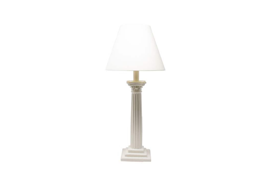 Corinthian candlestick lamp in clear glaze with an off white paper vellum lampshade, on a white background.