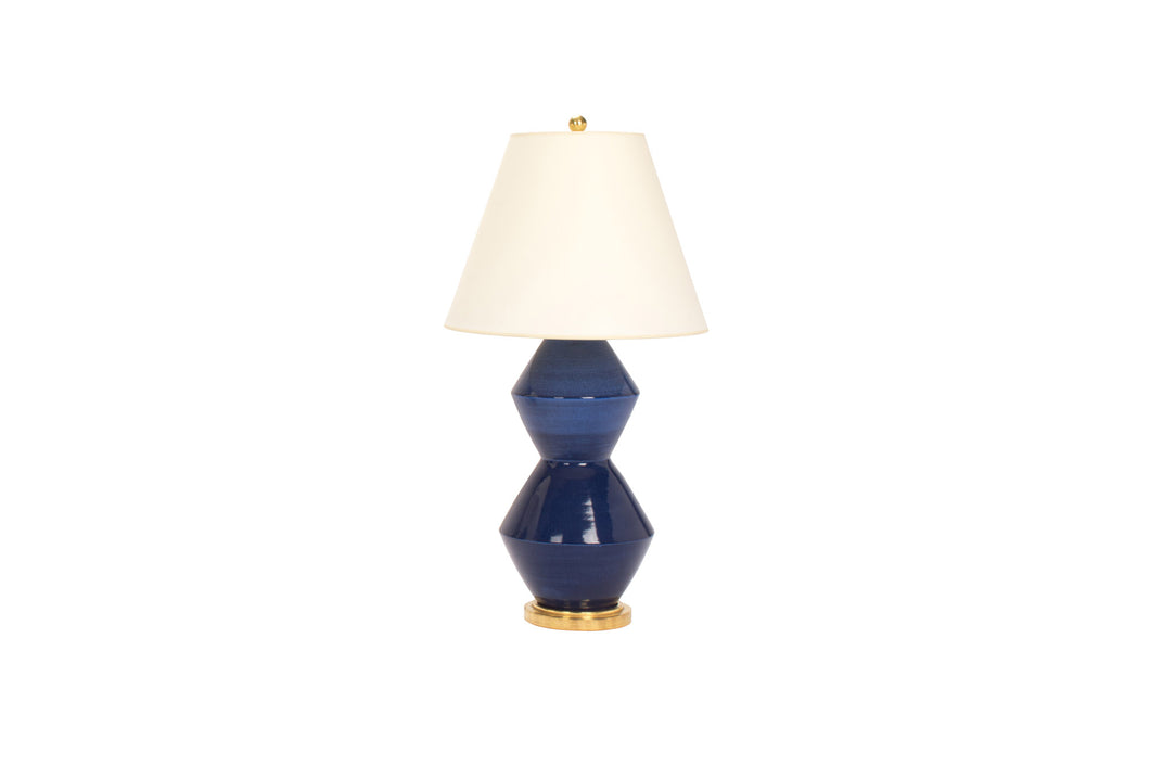 Medium David lamp in Prussian Blue glaze with 23k gold base, brass double socket cluster, and off white vellum paper lampshade, on a white background.