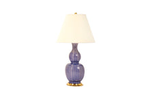 Delft table lamp in purple Wisteria glaze, with a 23k gold base, brass double socket cluster, and off white paper vellum lampshade, on a white background.