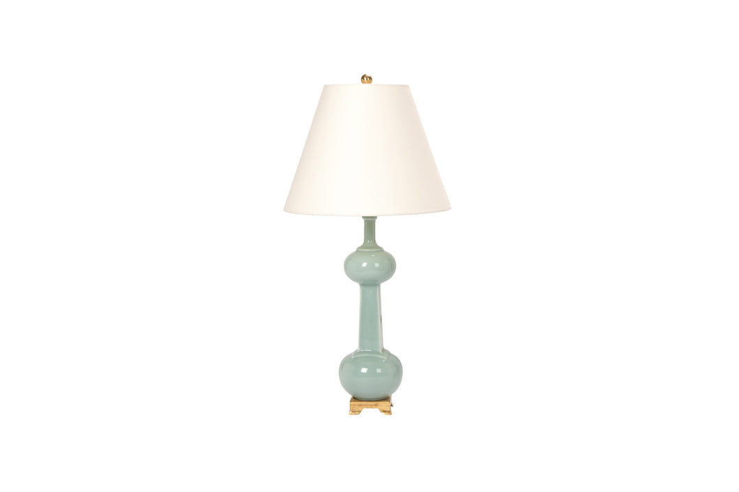 A single Medium Hadley lamp in duck egg glaze with 23k gold base, brass harp and dimmer, and off white vellum paper shade, on a white background.