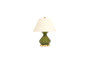 A single small Hager lamp in spruce green glaze with a 23k gold base, brass harp and dimmer socket, and off white vellum paper shade, on a white background.
