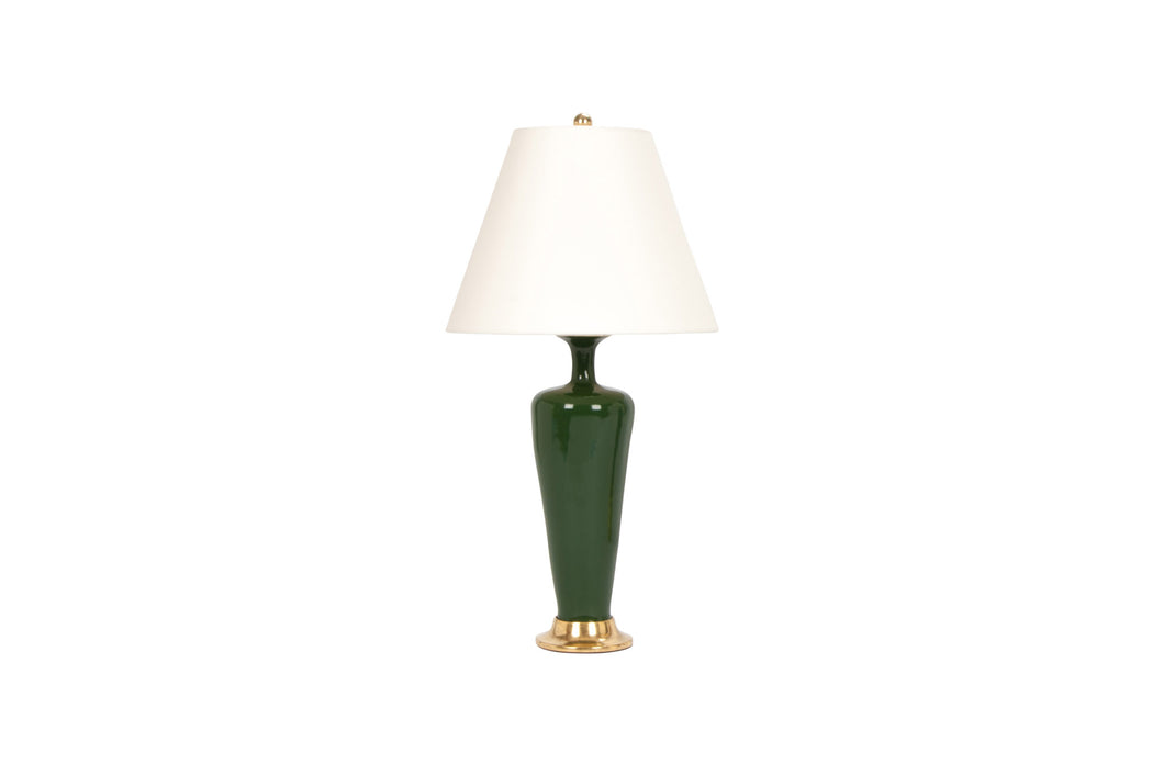 Small Anthony lamp in dark green glaze with 23k gold water gilt base, brass double socket cluster, and off white vellum paper shade, on a white background.